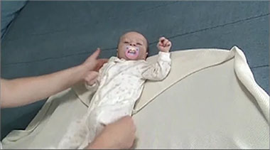 Image of baby being Swaddled